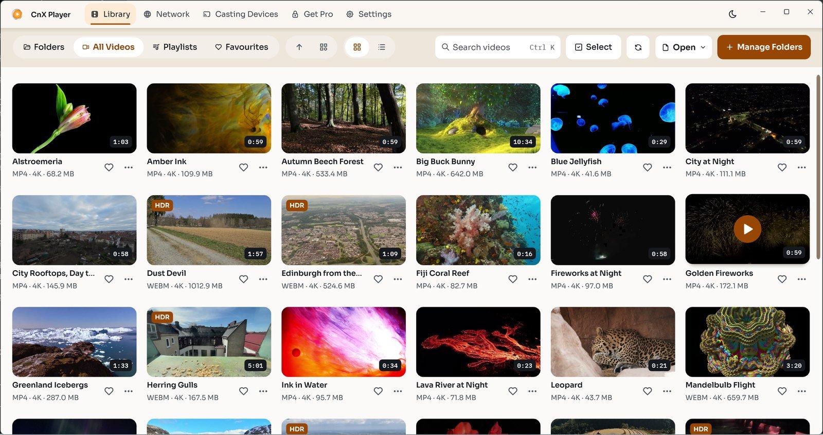 CnX Player's library in the light theme: a grid of video thumbnails with titles and details.
