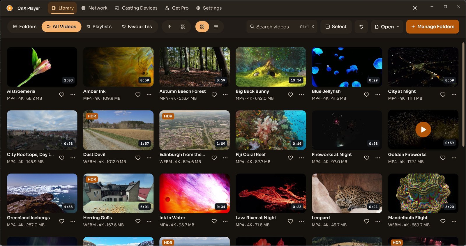 CnX Player's library in the dark theme: a grid of video thumbnails with titles and details.