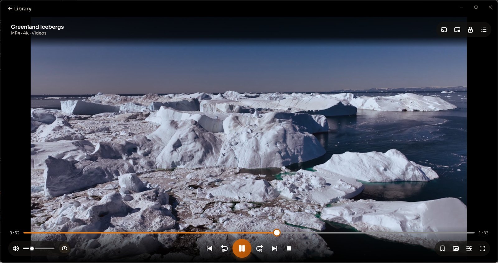 CnX's player showing a drone shot of icebergs, with the timeline and playback controls.